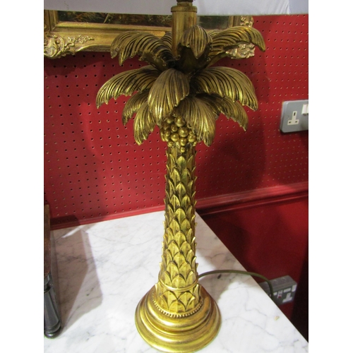 4042 - A gilt painted palm tree style table lamp with shade, 68cm tall