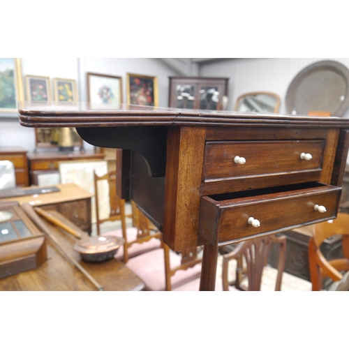 A Mahogany two drawer work table with drop flaps