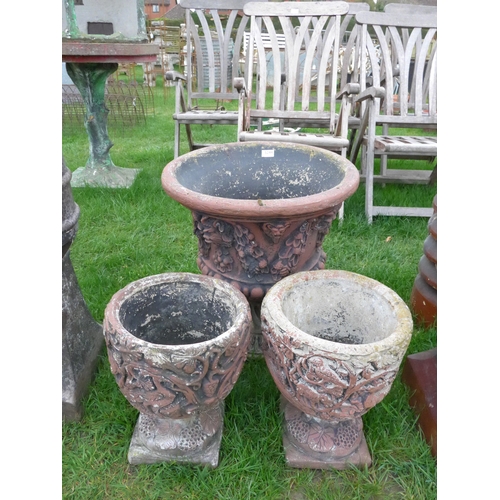 8026 - A pair of composition pots and similar planter on socle base (3)