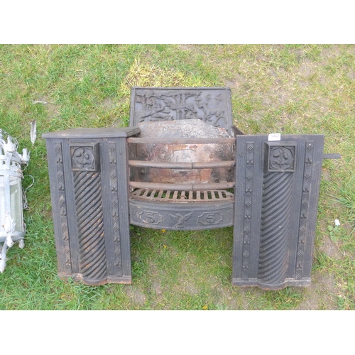 8033 - A Georgian cast iron hob grate with decorative back