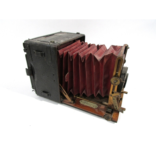 7009 - An early 20th Century Sanderson of London Hand and Stand quarter-plate camera with red bellows, seri... 