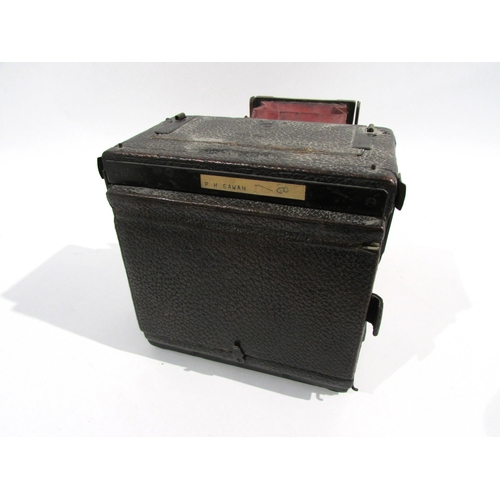 7009 - An early 20th Century Sanderson of London Hand and Stand quarter-plate camera with red bellows, seri... 