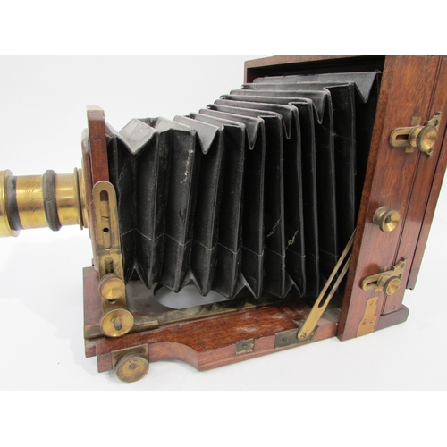7003 - A Lancaster's Patent mahogany and brass half-plate field camera, black bellows in good order, unname... 