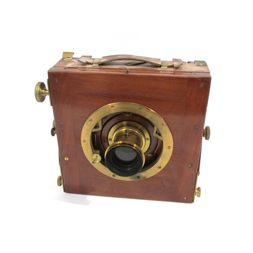 7004 - A mahogany and brass half-plate field camera with unnamed brass lens, black bellows in good order, w... 