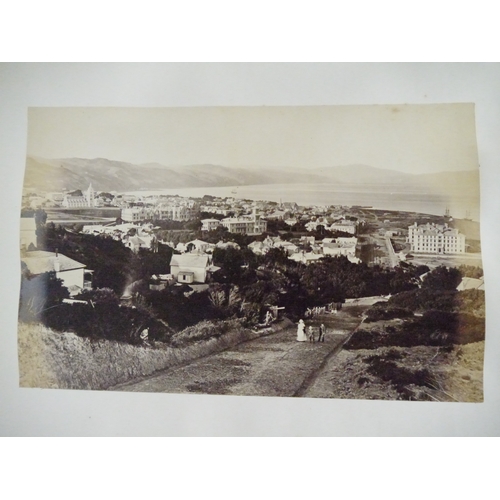 9044 - A 19th Century photograph album containing approx. 100 mounted albumen print etc photographs mainly ... 