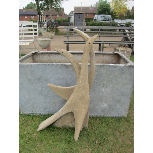 8059 - A Deco style garden feature of abstract entwined swans, 93cm tall