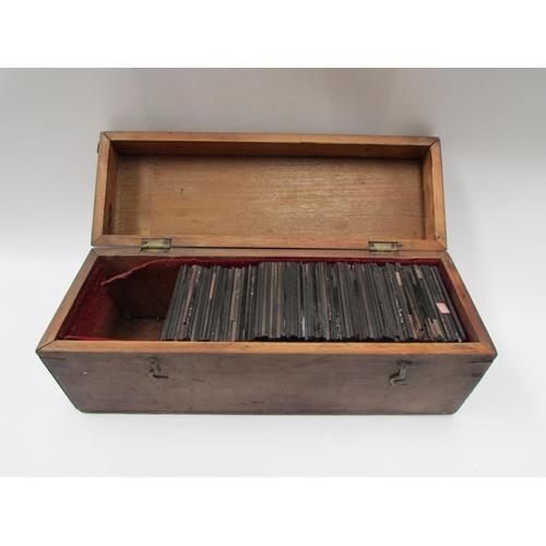 7032 - A cased collection of mixed interest glass magic lantern slides. Contains various World scenes inclu... 