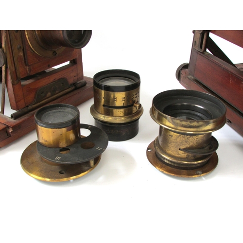 7013 - Two Victorian mahogany and brass cased field cameras, one a quarter plate example, together with thr... 