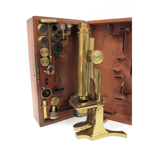 7041 - A mid 19th Century Smith & Beck brass microscope, housed within a wooden case, the microscope inscri... 
