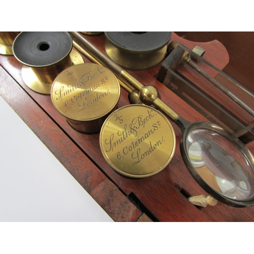 7041 - A mid 19th Century Smith & Beck brass microscope, housed within a wooden case, the microscope inscri... 