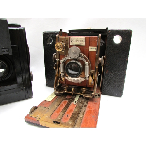 7011 - A Sanderson Hand and Stand plate camera with brass fittings and mahogany body, housed in a black lea... 