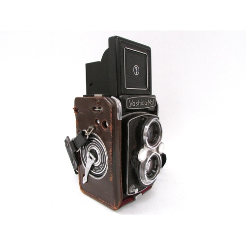 7056 - A Yashica-Mat Copal MXV TLR twin lens film camera, integral Yashinon 80mm lenses, in worn leather ca... 