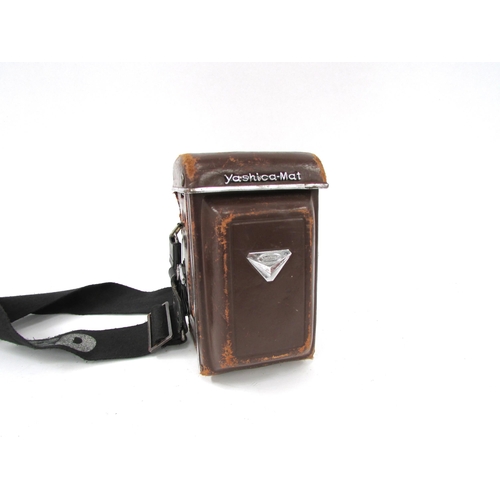 7056 - A Yashica-Mat Copal MXV TLR twin lens film camera, integral Yashinon 80mm lenses, in worn leather ca... 