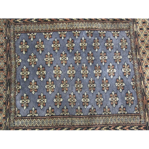 4010 - A blue and brown pattern prayer rug with tasselled ends, 62cm x 47cm