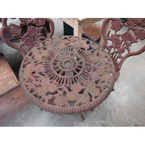2028A - A cast iron garden table and two chairs