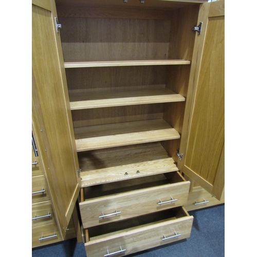 1037 - A modern light oak two door over two drawers cupboard, 184cm tall