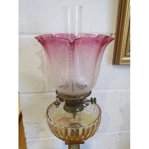1020 - A Victorian brass column oil lamp with cranberry acid etched shade