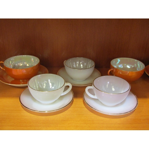 1035 - Six Arcopal vaseline glass and gilt tea cups and saucers, eight orange lustre ware tea cups and seve... 