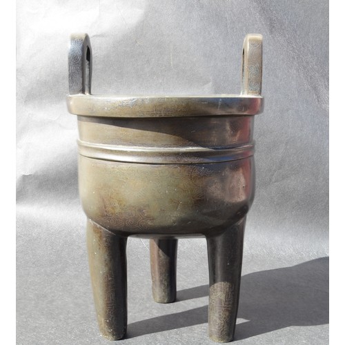 7001 - A bronze 18thc Chinese silver inlaid twin handled tripod ding (censer) profusely inlaid arcahaic sty... 
