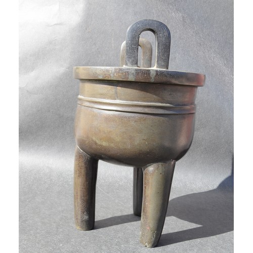 7001 - A bronze 18thc Chinese silver inlaid twin handled tripod ding (censer) profusely inlaid arcahaic sty... 