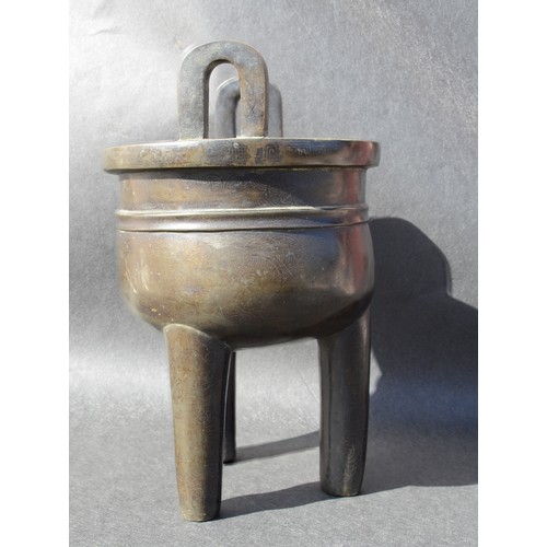 7001 - A bronze 18thc Chinese silver inlaid twin handled tripod ding (censer) profusely inlaid arcahaic sty... 