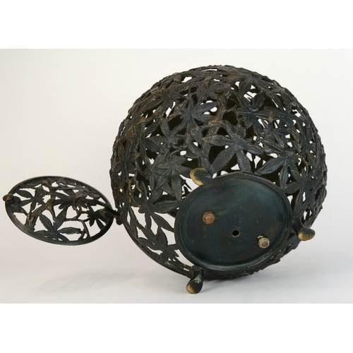 7002 - A bronze Japanese spherical openwork lantern decorated with bamboo leaves, converted to hold a light... 
