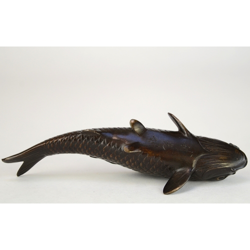 7007 - A Japanese bronze okimono of a carp, signed

 9.5cm wide

 Provenance
 Henry Potter Stevens Collecti... 