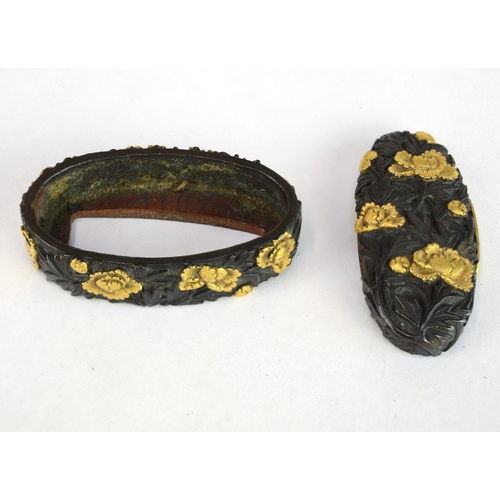 7009 - A fuchi and gashira (pommel and hilt) set decorated with peonies in shakudo and gilt takazogan, unsi... 