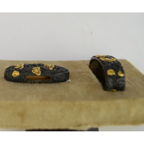 7009 - A fuchi and gashira (pommel and hilt) set decorated with peonies in shakudo and gilt takazogan, unsi... 