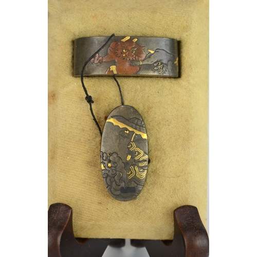 7010 - A fuchi and gashira (pommel and hilt) set depicting onis and Shoki riding a shishi, signed

 Provena... 