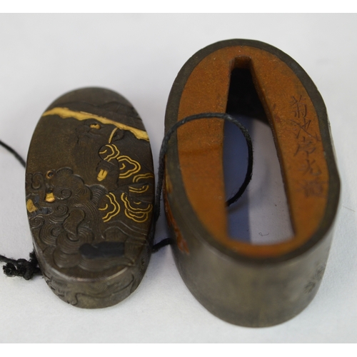 7010 - A fuchi and gashira (pommel and hilt) set depicting onis and Shoki riding a shishi, signed

 Provena... 