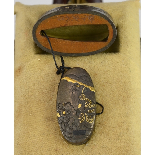 7010 - A fuchi and gashira (pommel and hilt) set depicting onis and Shoki riding a shishi, signed

 Provena... 