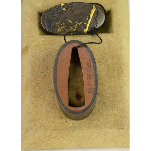 7010 - A fuchi and gashira (pommel and hilt) set depicting onis and Shoki riding a shishi, signed

 Provena... 
