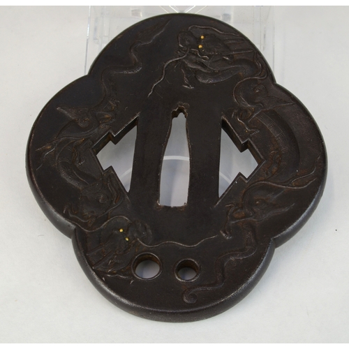 7012 - An iron mokko gata tsuba decorated in relief with dragons with gold eyes, the other side decorated w... 