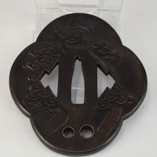 7012 - An iron mokko gata tsuba decorated in relief with dragons with gold eyes, the other side decorated w... 