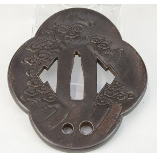 7012 - An iron mokko gata tsuba decorated in relief with dragons with gold eyes, the other side decorated w... 