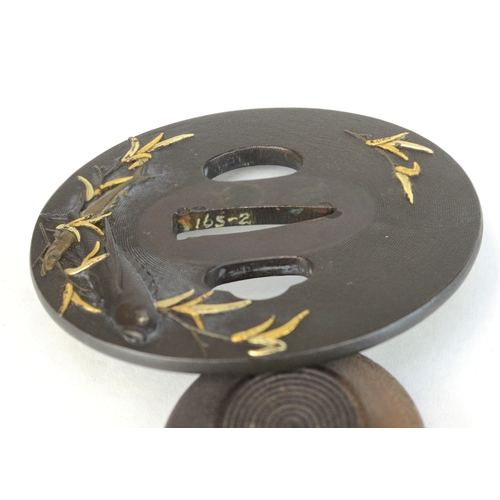 7015 - A shakudo tsuba decorated with takazogan fish and bamboo stems with gold leaves, the other side deco... 
