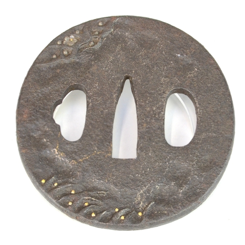 7016 - A small oval iron tsuba decorated in shishiaibori and takazogan depicting a man seated beneath a che... 