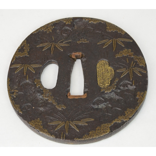 7023 - Three iron tsuba one decorated with prunus, one in Shoami style with leaves and the third with bambo... 