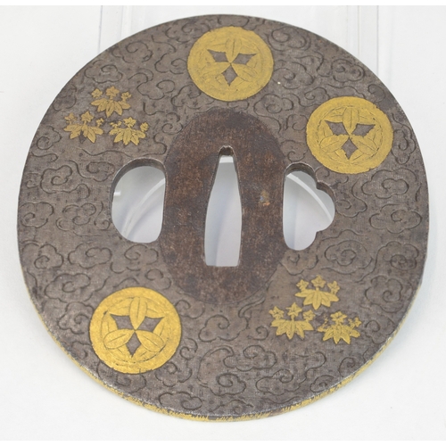 7025 - An oval steel tsuba decorated with hirazogan gilt Takenaka kamon (mons) and lotus flowers, the backg... 