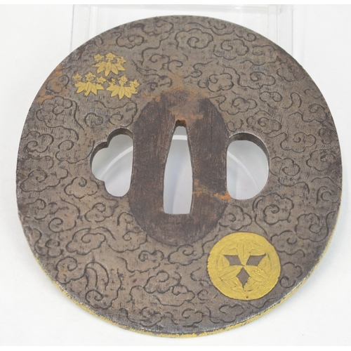 7025 - An oval steel tsuba decorated with hirazogan gilt Takenaka kamon (mons) and lotus flowers, the backg... 