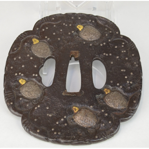 7031 - KANEIYE- An iron tsuba decorated with steel turtles in shishiaibori with gilt heads, signed 

 Prove... 