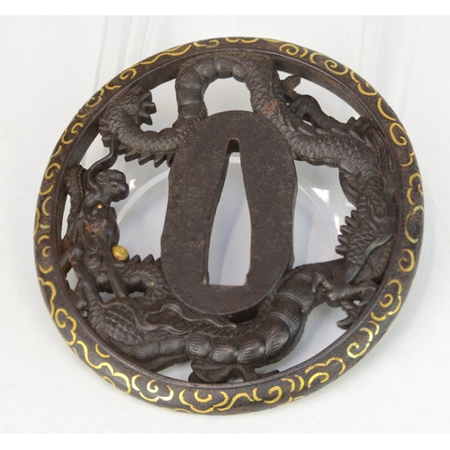7036 - An iron dragon sukashi (openwork) tsuba decorated with a dragon surrounding the nakago, the exterior... 