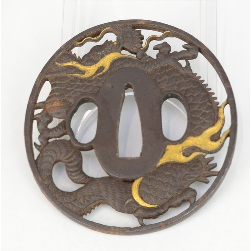 7041 - An iron openwork tsuba decorated with a dragon circling the nakago, unsigned

 Provenance
 Henry Pot... 