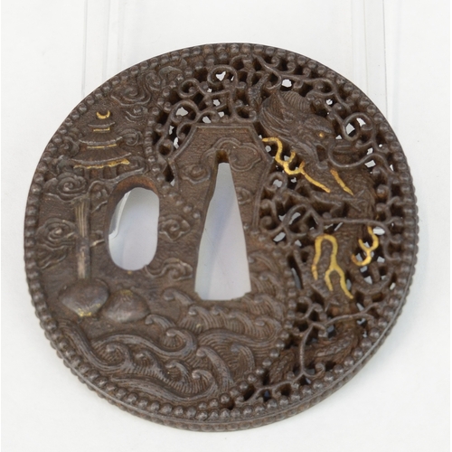 7043 - An iron openwork tsuba decorated with a dragons, waves and a pagoda style house, unsigned

 Provenan... 