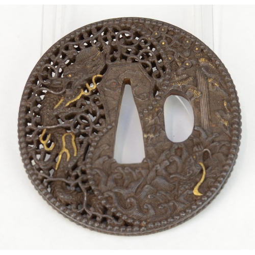 7043 - An iron openwork tsuba decorated with a dragons, waves and a pagoda style house, unsigned

 Provenan... 