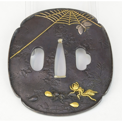 7044 - GOTO MITSUYOSHI A shakudo tsuba with gold, shakudo and silver ants carrying eggs together with a but... 
