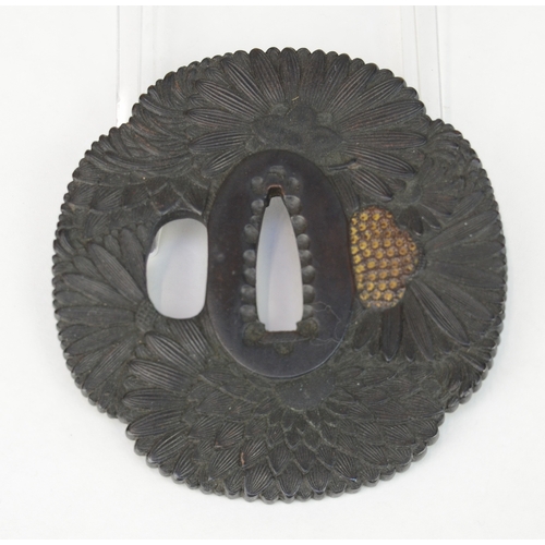 7045 - A shakudo tsuba decorated with chrysanthemums, unsigned

 Provenance
 Humphrey Stevens purchased 25/... 