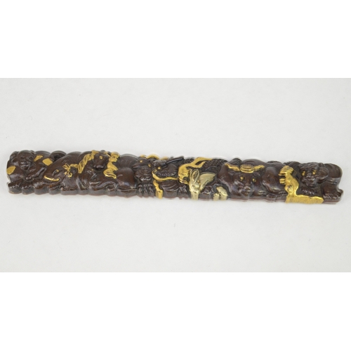 7055 - A mixed metal kozuka decorated in shakudo, gold and silver in high relief depicting all twelve junis... 