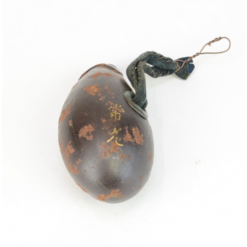 7063 - Three Japanese metal items to include a solid metal aubergine netsuke signed Tsunemitsu  together wi... 
